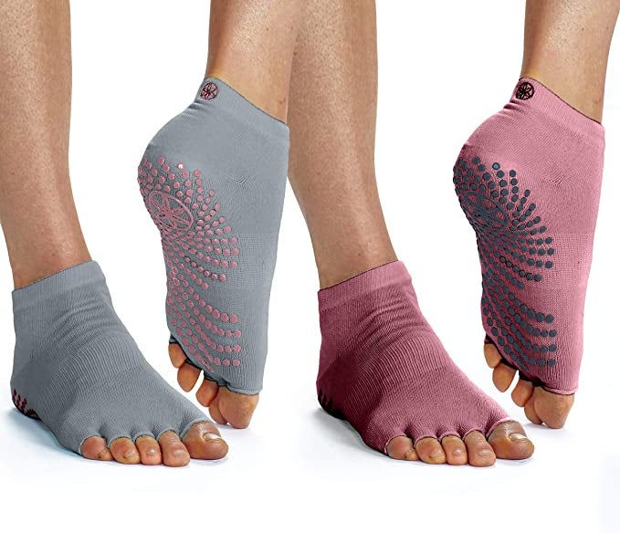 two pairs of feet with toeless socks with grips on the bottom