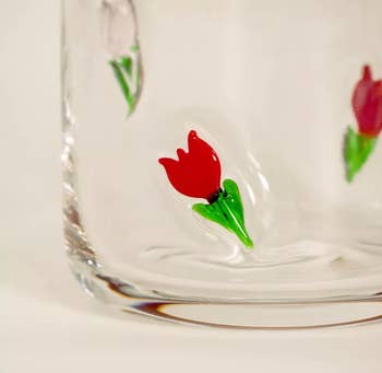 Clear glass with embossed red tulip design, suitable for home decor or gifting. 