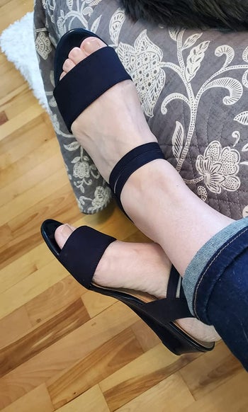 reviewer wearing black wedge sandals