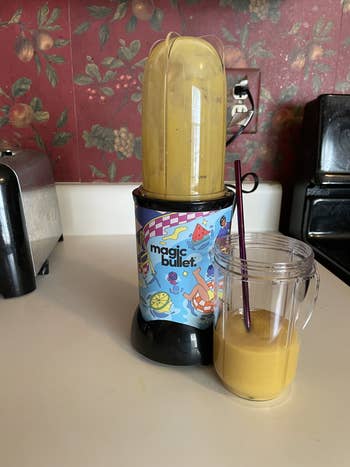 a mango drink in the party mug, placed beside the blender