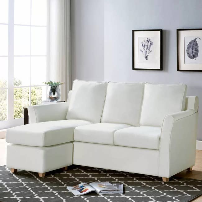L-shaped sectional sofa with left-facing chaise in a minimalist living room setting