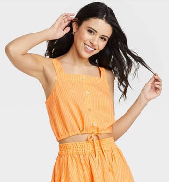 model wearing the orange top