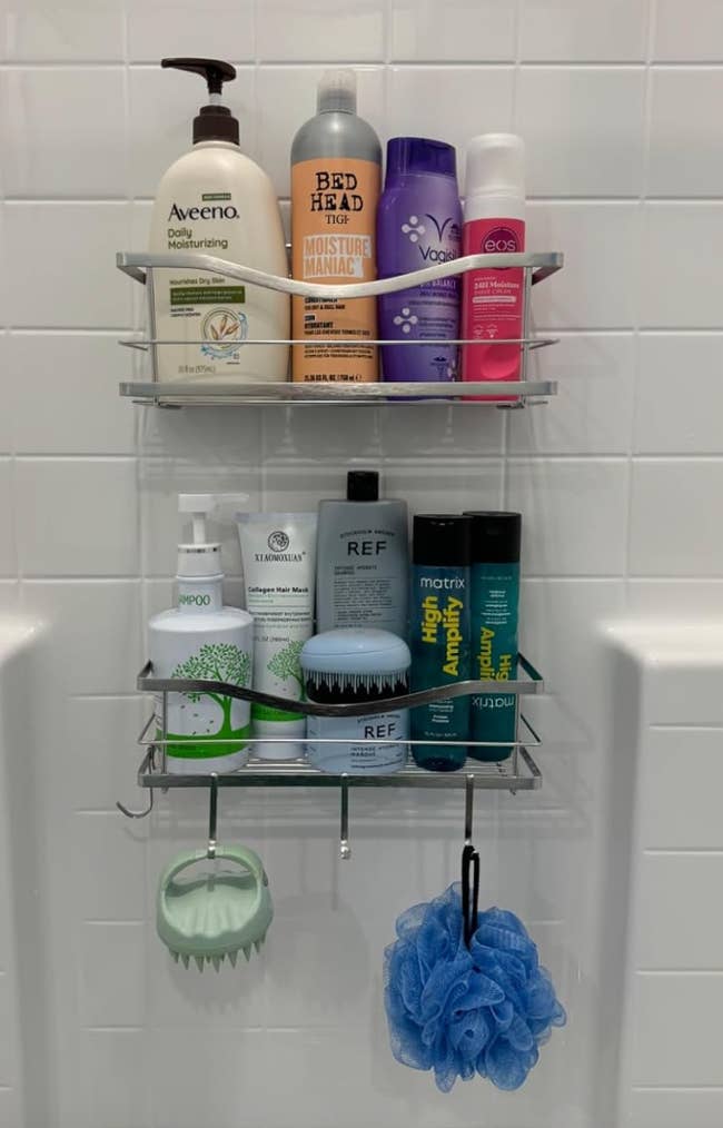 Shower caddy holding Aveeno lotion, Bed Head & V05 shampoo, EOS shave cream, Luomoo soap, REF skincare products, Matrix & It's a 10 hairsbreadth  treatment, greenish  brush, and bluish  loofah