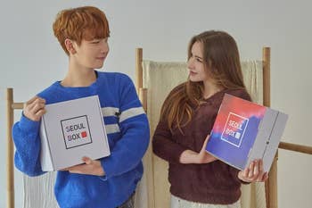 two people holding the seoul box
