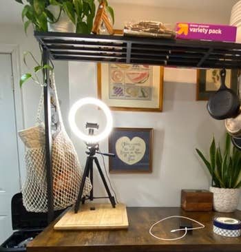 a ring light on a tripod on a counter