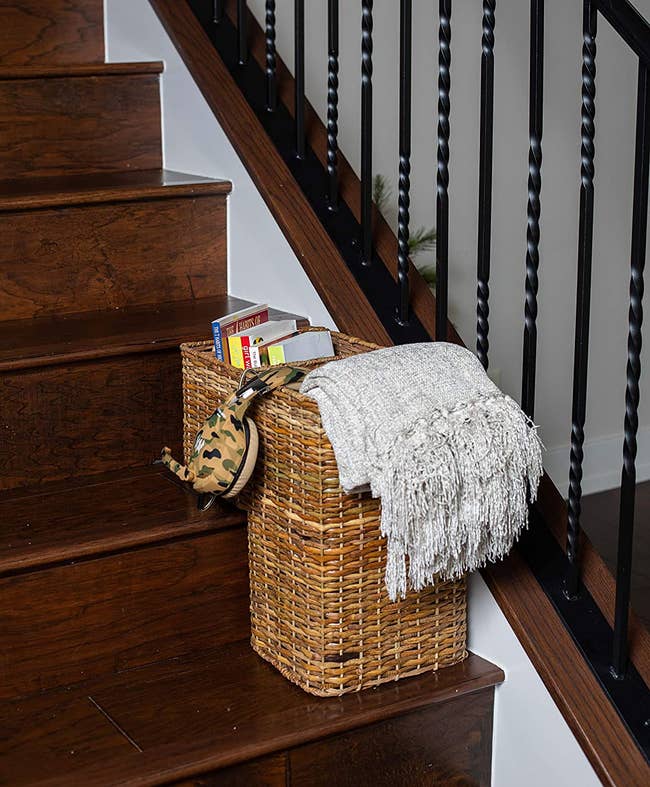 the two-compartment wicker basket on a set of stairs