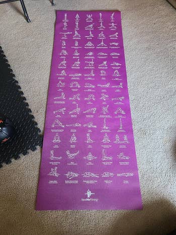 another reviewer's purple yoga mat with poses on them