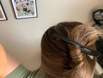 reviewer photo of the black salon clip holding up a bun