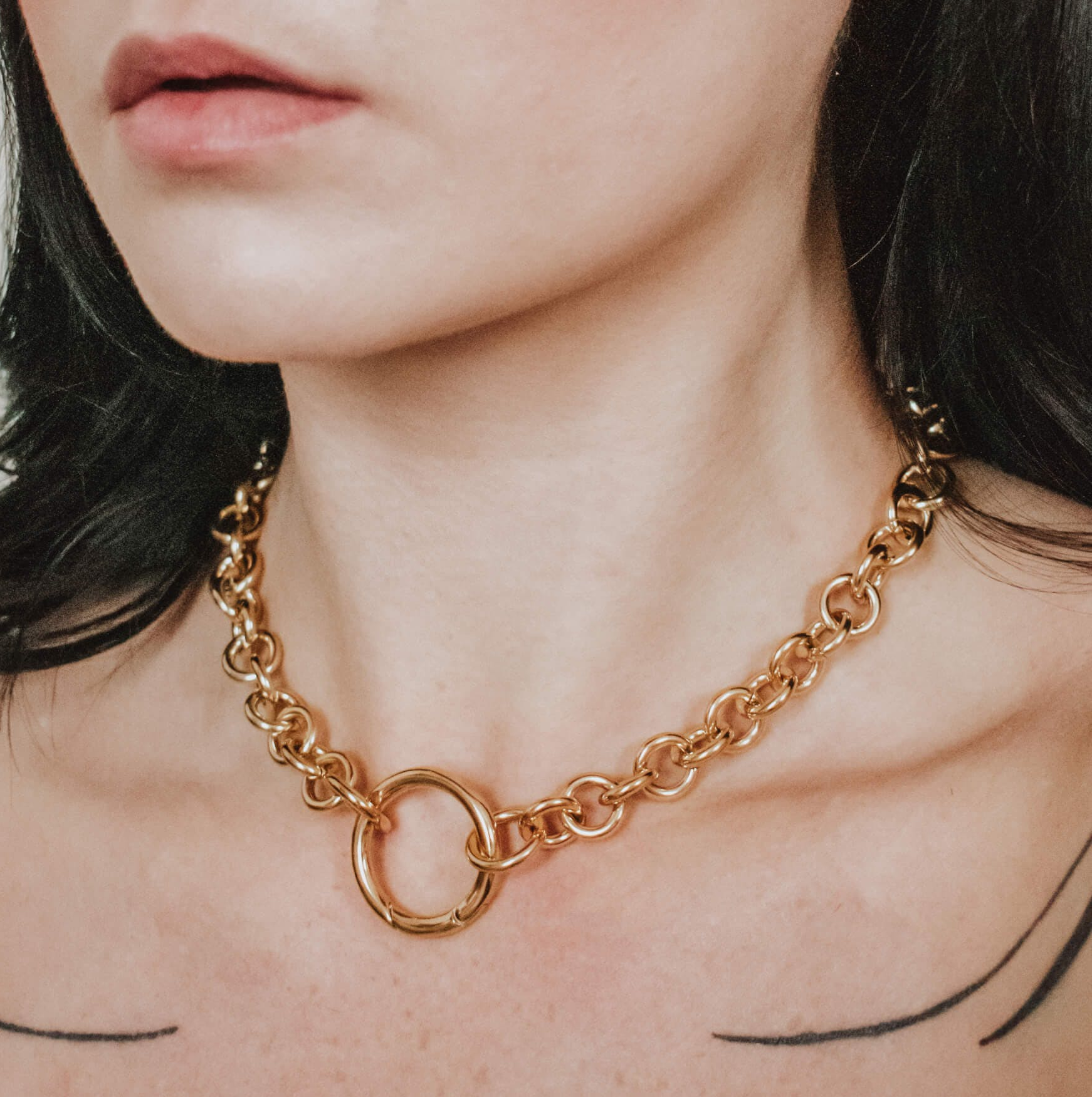 Model wearing gold chain necklace