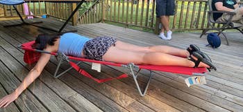 Reviewer lying on their stomach on the lounger