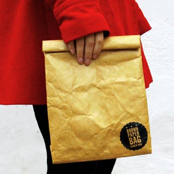 model holding reusable brown paper bag