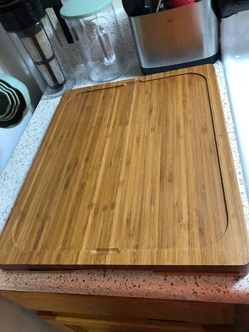 reviewer shows one side of the  cutting board