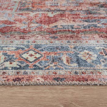 Close-up of an intricately patterned rug with geometric designs connected  a woody  floor, suggesting location  decor oregon  interior shopping