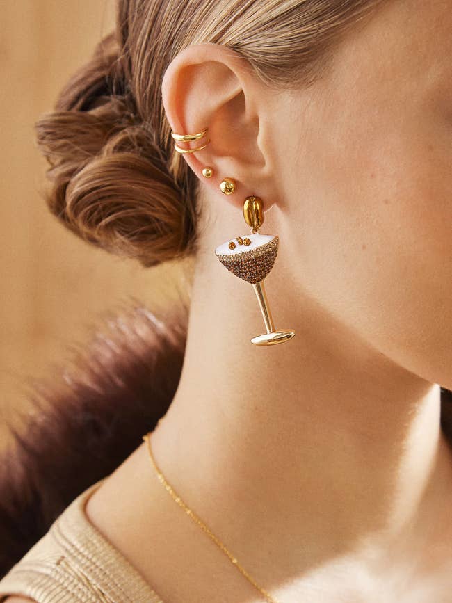 Model wearing a drop earring shaped like a crystallized espresso martini 