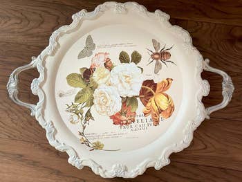 Decorative tray with botanical and insect illustrations rub on tand Latin text, featuring two handles