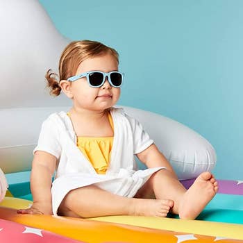 a toddler wearing the blue sunglasses