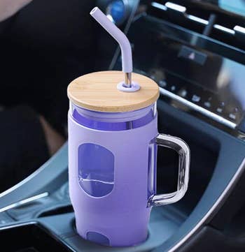 a purple cup in a car cupholder