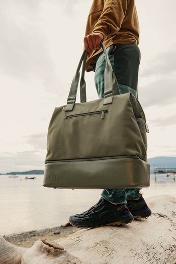 model carrying green mini weekender
