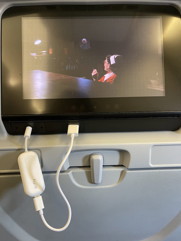reviewer photo of the airfly pro being used on a plane