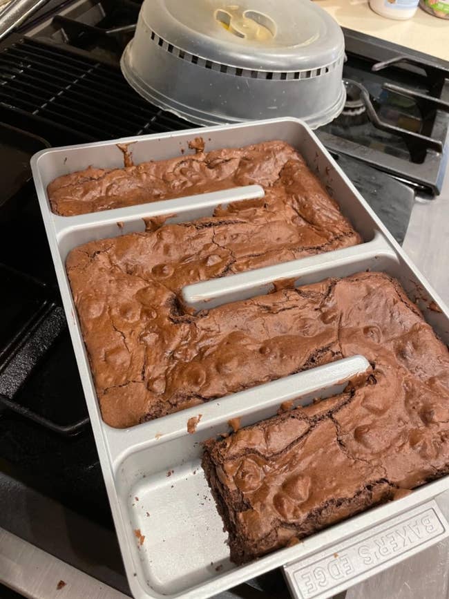 Reviewer image of cooked brownies in the pan shaped in an s-like curve for maximum edges