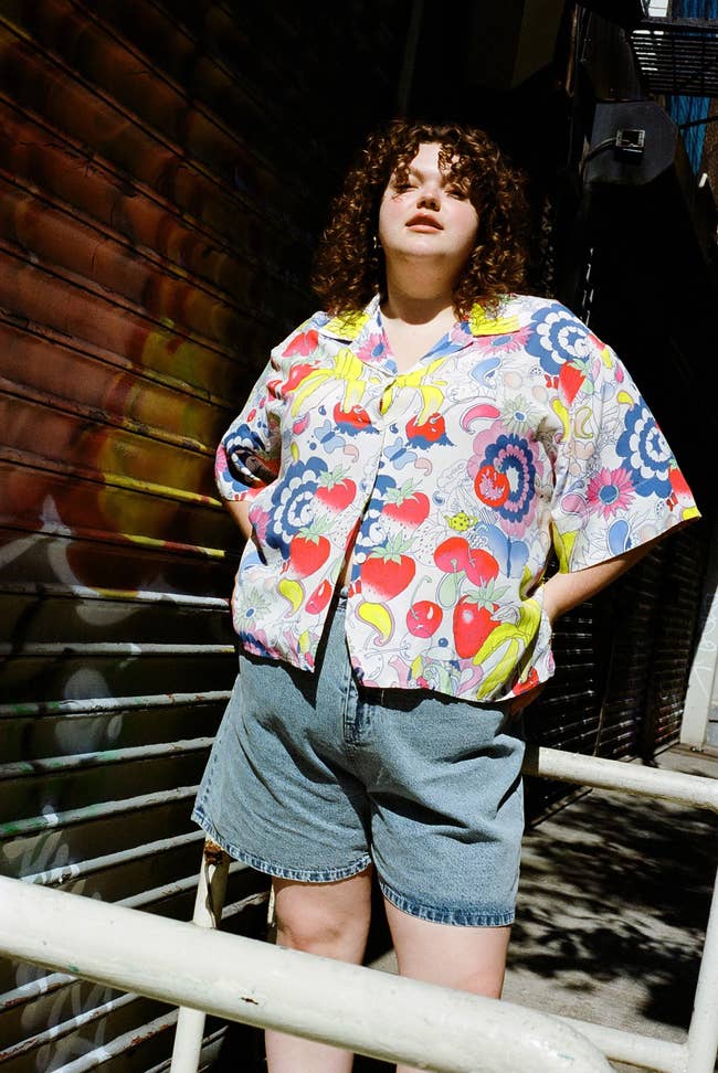 model in button down shirt with psychedelic print