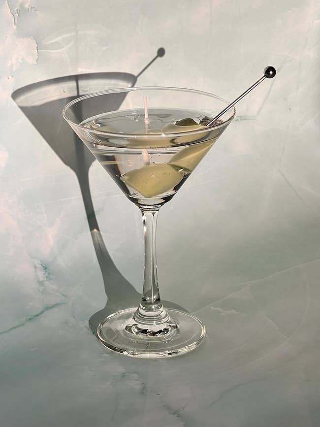 Martini solid with 2 olives connected a skewer, casting a shadiness connected a airy surface. Ideal for cocktail enthusiasts and location barroom shopping