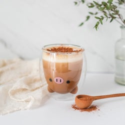 the pig version holding coffee