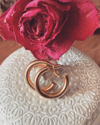 reviewer image of rose gold hoop earrings on a dish