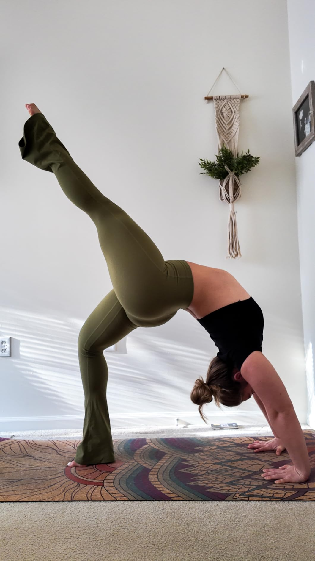 A reviewer wearing the leggings while doing yoga