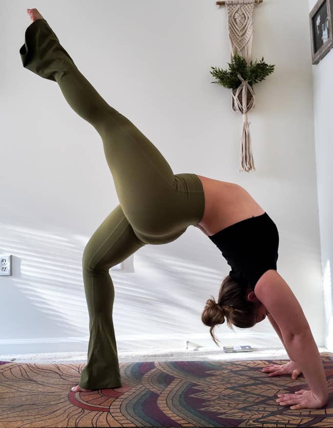 A reviewer wearing the leggings while doing yoga