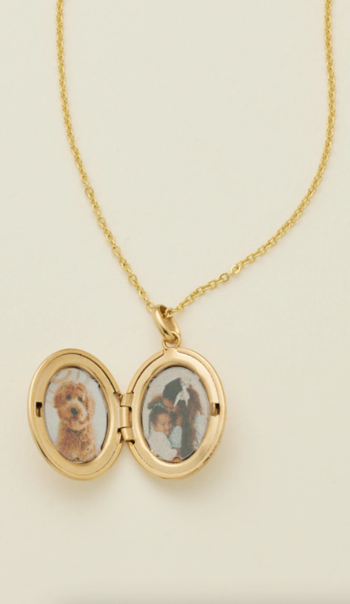 an open locket with a photo of a dog and kids