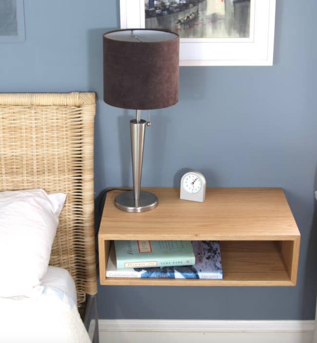 the floating nightstand next to a bed