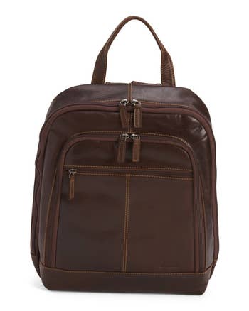 Brown leather backpack with compartments and stitching details. Ideal for stylish, practical use