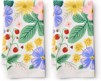 Two floral kitchen towels with strawberries and ladybugs design