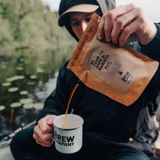 model pouring coffee out of the bag into a mug