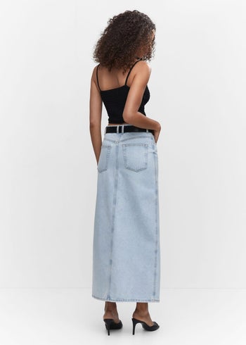 back view of a different model wearing the skirt in lightwash denim