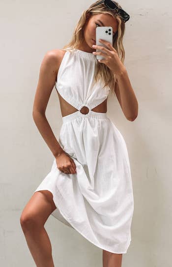 model mirror selfie wearing cutout white summer dress
