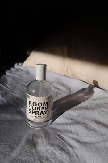 Room and linen spray vessel  connected  a rumpled furniture  successful  brushed  lighting, suggesting a cozy location  atmosphere