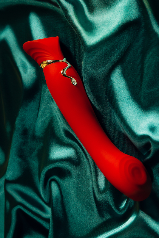 Red g-spot vibrator on green velvet blanket