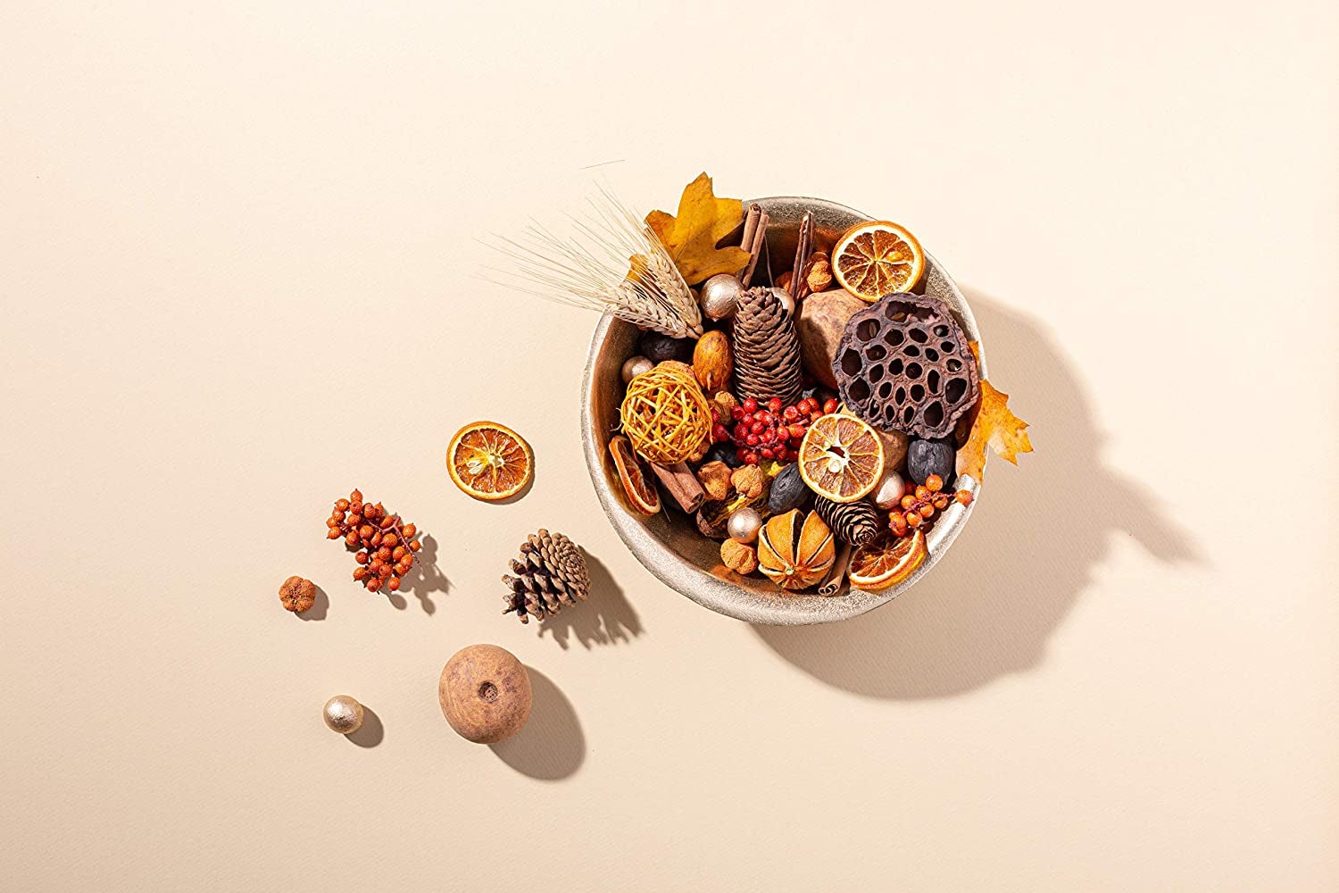 bowl of harvest potpourri with orange slices and other dried and preserved natural items