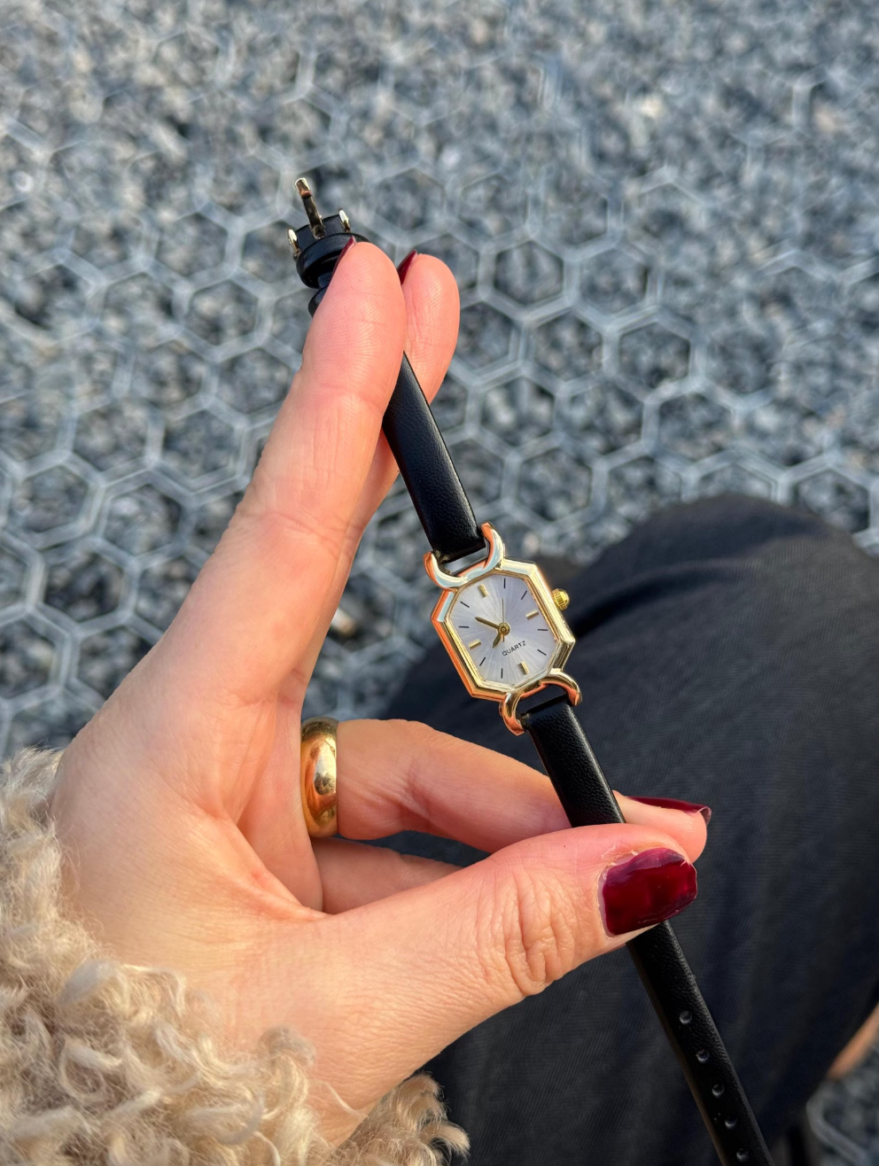 hand holding the ticker  with a achromatic  leather strap