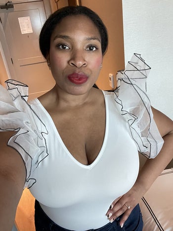 a reviewer wearing the top in white