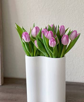 reviewer's white vase filled with purple tulips