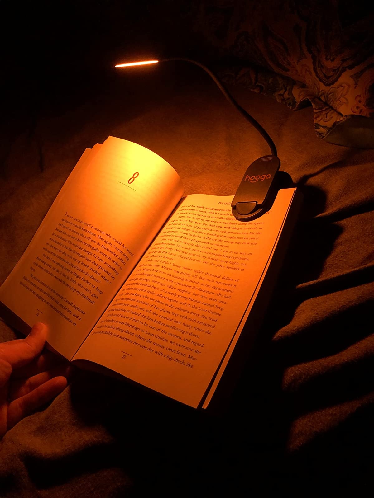 reviewer image of the warm yellow light clipped onto their book