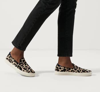model wearing the leopard print slip ons