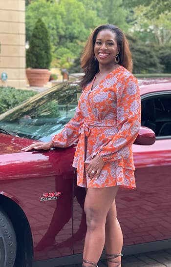 a different reviewer wearing the  orange and purple floral romper