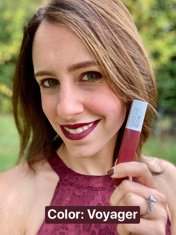 reviewer wearing a dark red shade of the lipstick