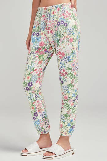 model in white sweats with colorful flowers