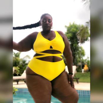 reviewer wearing the criss-cross swimsuit in bright yellow
