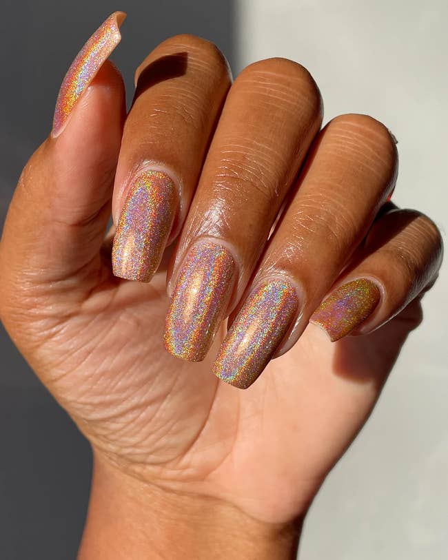 A model with holographic rose gold nails 